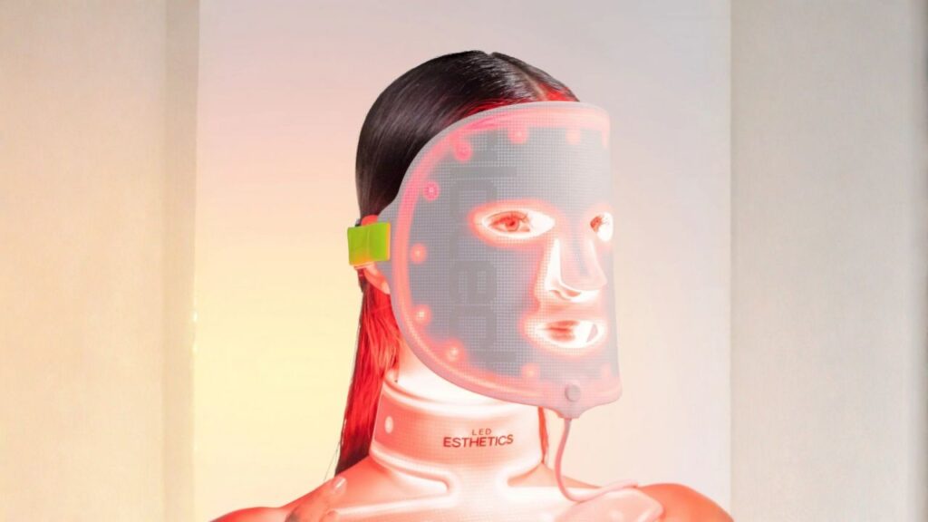 A tester tries out an LED light therapy mask during our review process. Red light (around 630 nm) penetrates to boost collagen and reduce wrinkles, while other colors like blue aim to calm acne. All the masks we selected use safe, therapeutic light intensities to improve skin with consistent use.