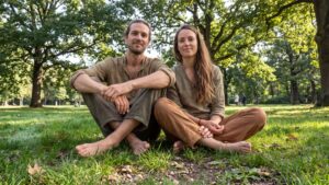 a man and a woman grounding on the grass