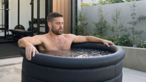 a man doing a cold plunge after a workout